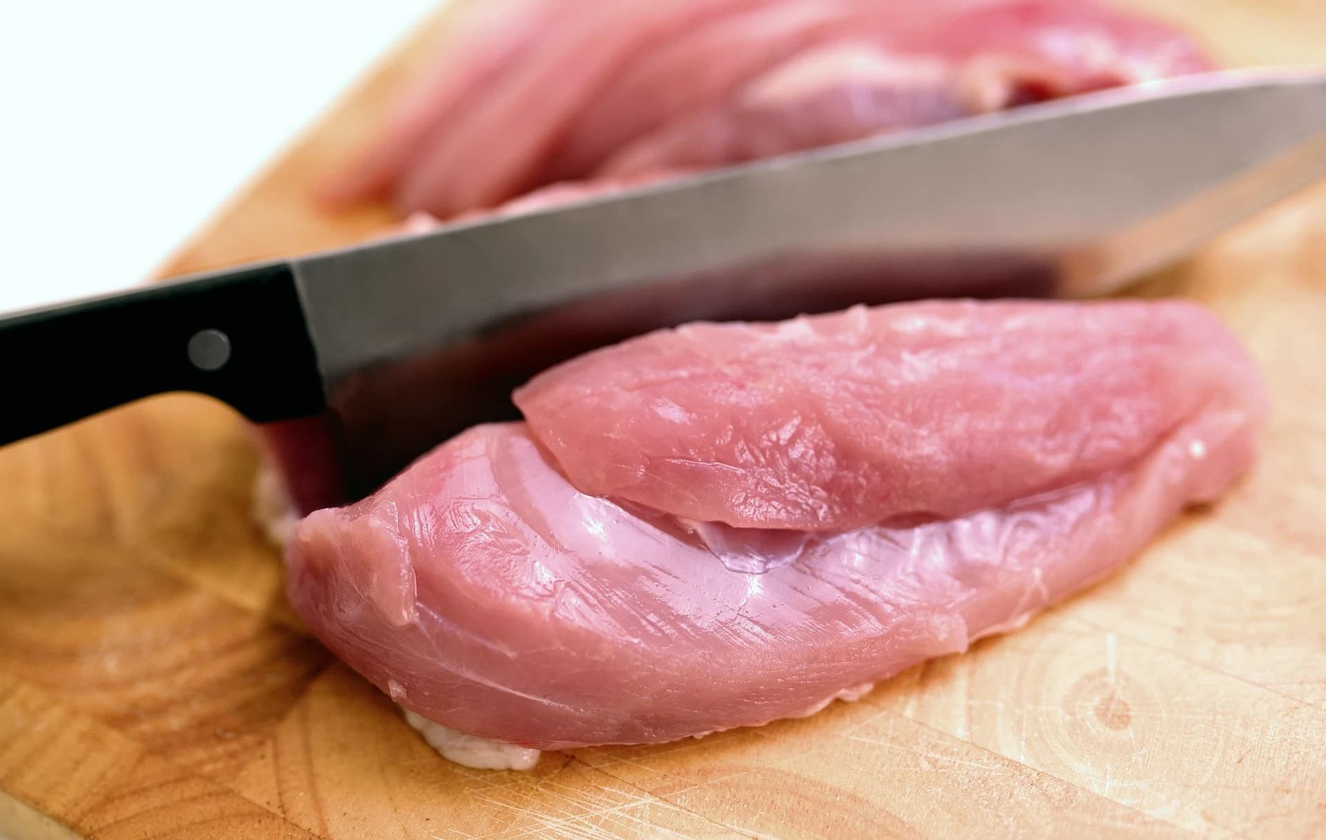 A lean raw meat cut being prepared